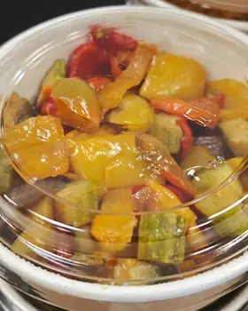 Una vaschetta di peperonata con zucchine