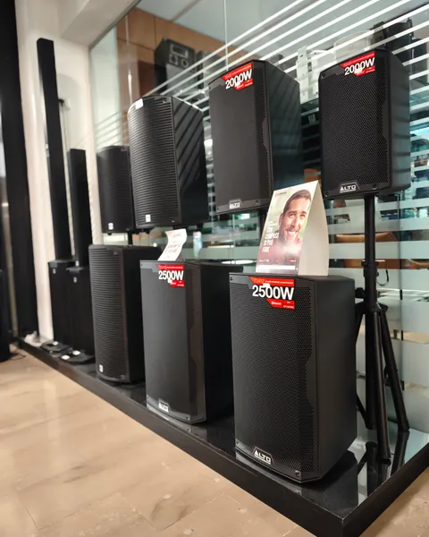 Casse amplificate nere da 2000 e 2500 watt esposte in negozio, su una pedana davanti alla vetrata