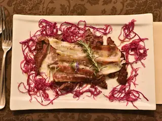 Carne al forno con rosmarino su un letto di cavolo rosso