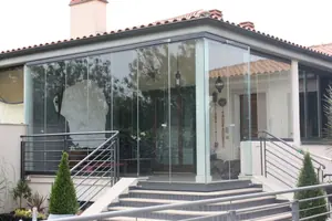 Veranda con vetrate panoramiche davanti a una villetta